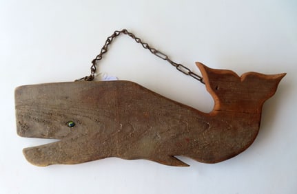 A carved wooden silhouette whale, probably an old trade sign