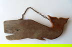 A carved wooden silhouette whale, probably an old trade sign