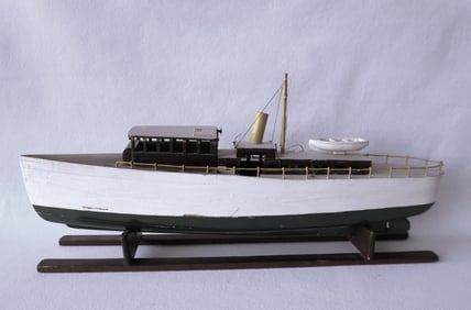 A handmade wooden boat model in original paint, solid laminated hull construction, early to mid 20tA