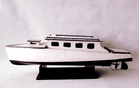 A handmade wooden cabin cruiser boat model in original paint. This would have been a working boat