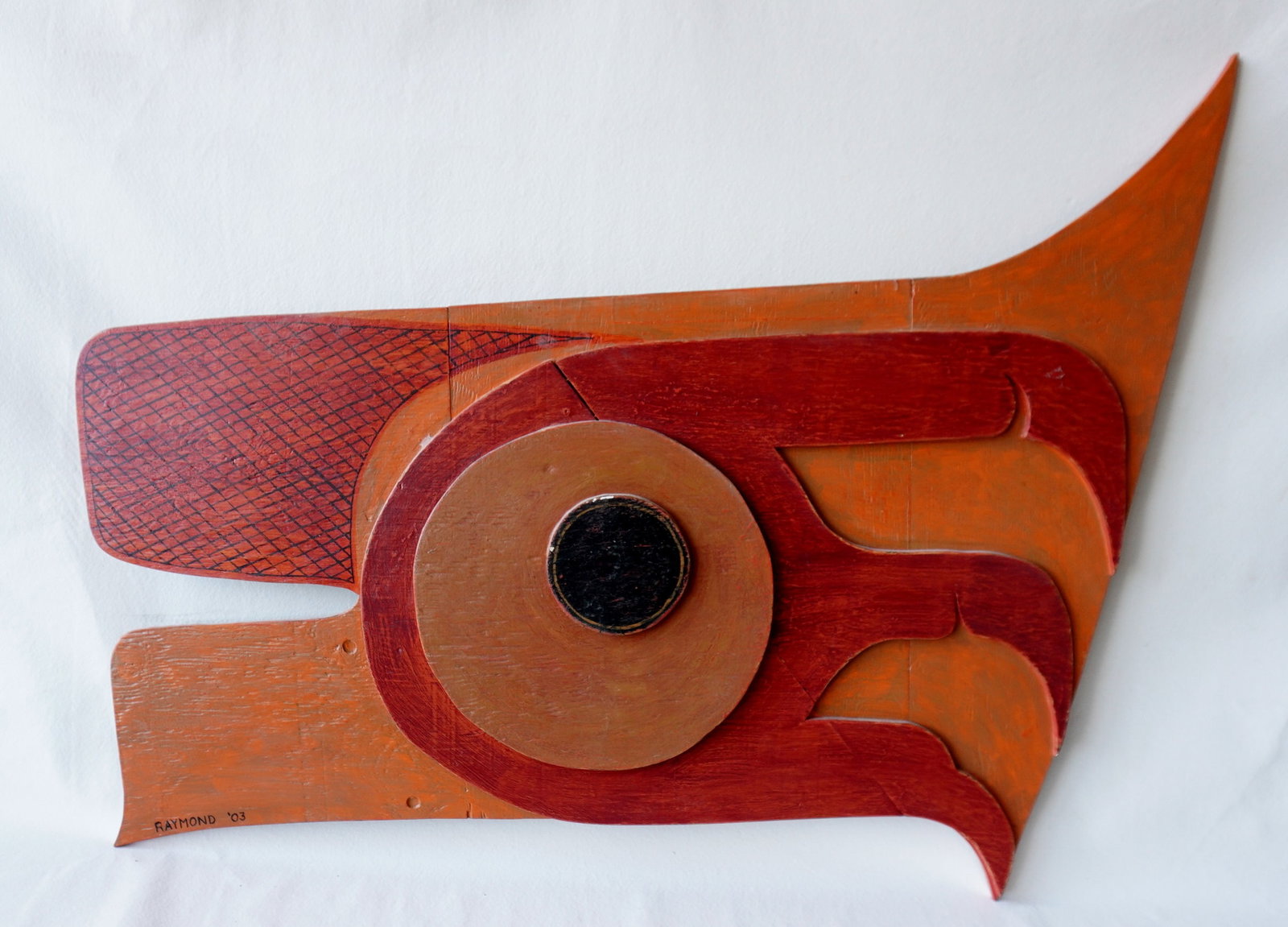 A Jeff Raymond custom made Northwest Coast style wooden wall plaque in the form of a stylized eagle: A Jeff Raymond custom made Northwest Coast style wooden wall plaque in the form of a stylized eagle head, in original paint, signed Raymond '03. Measures 50"W x 39"H. Very good condition. Provenance: 
