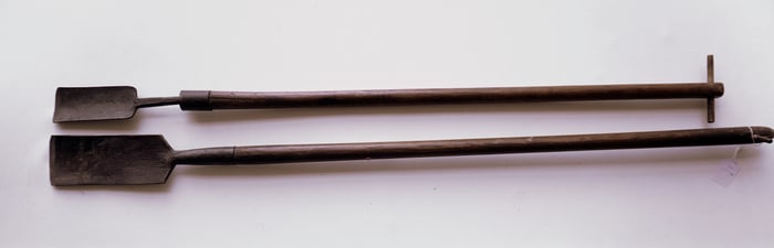 Two hand forged iron blubber gouges, 18th/19th century, both with long wooden handles and in good