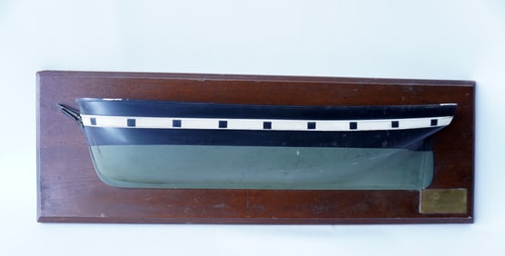 A half hull ship model with brass plaque that reads "Bark Charles W. Morgan (dimensions) 1841",
