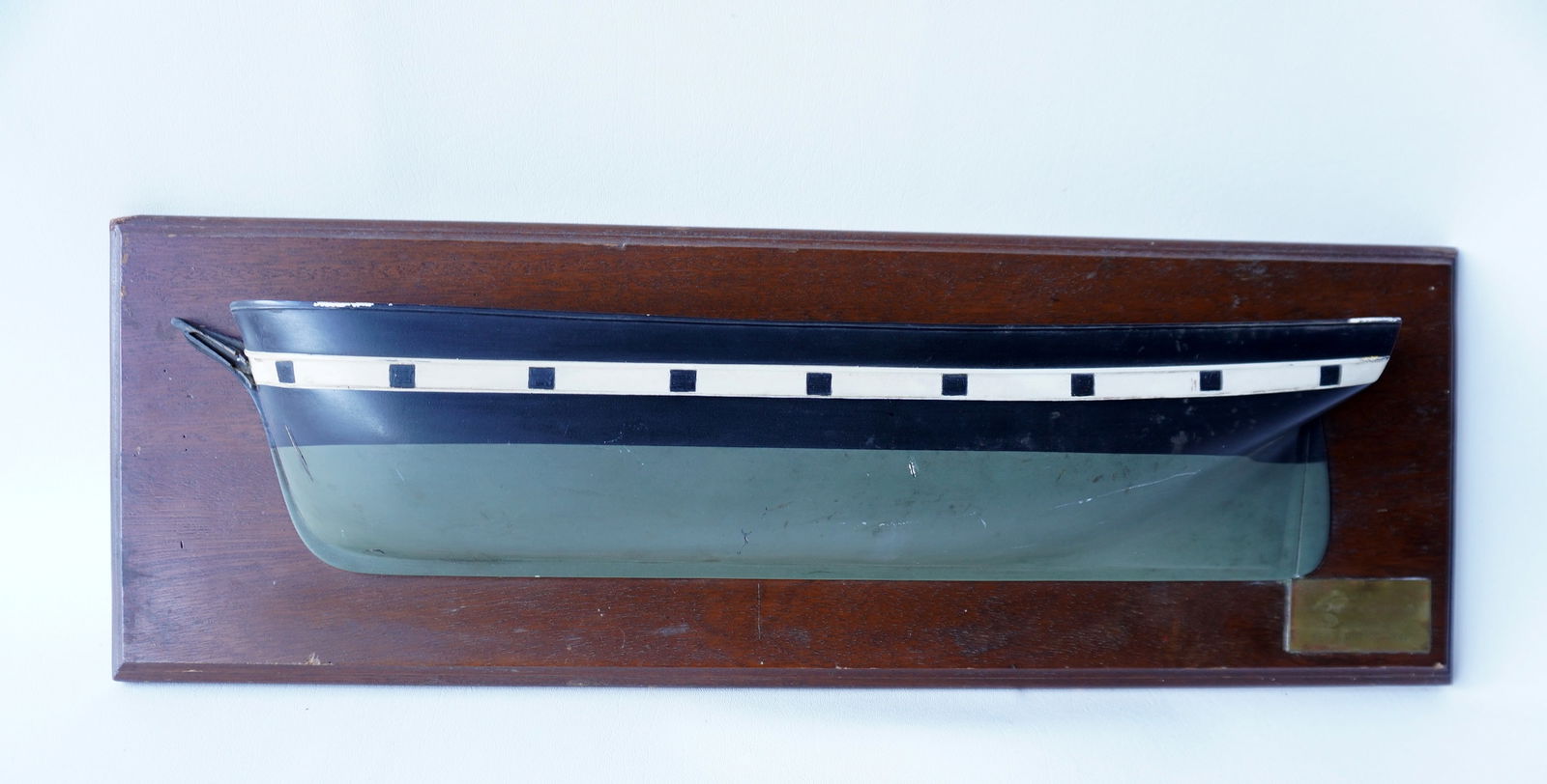 A half hull ship model with brass plaque that reads "Bark Charles W. Morgan (dimensions) 1841", (1 of 7)