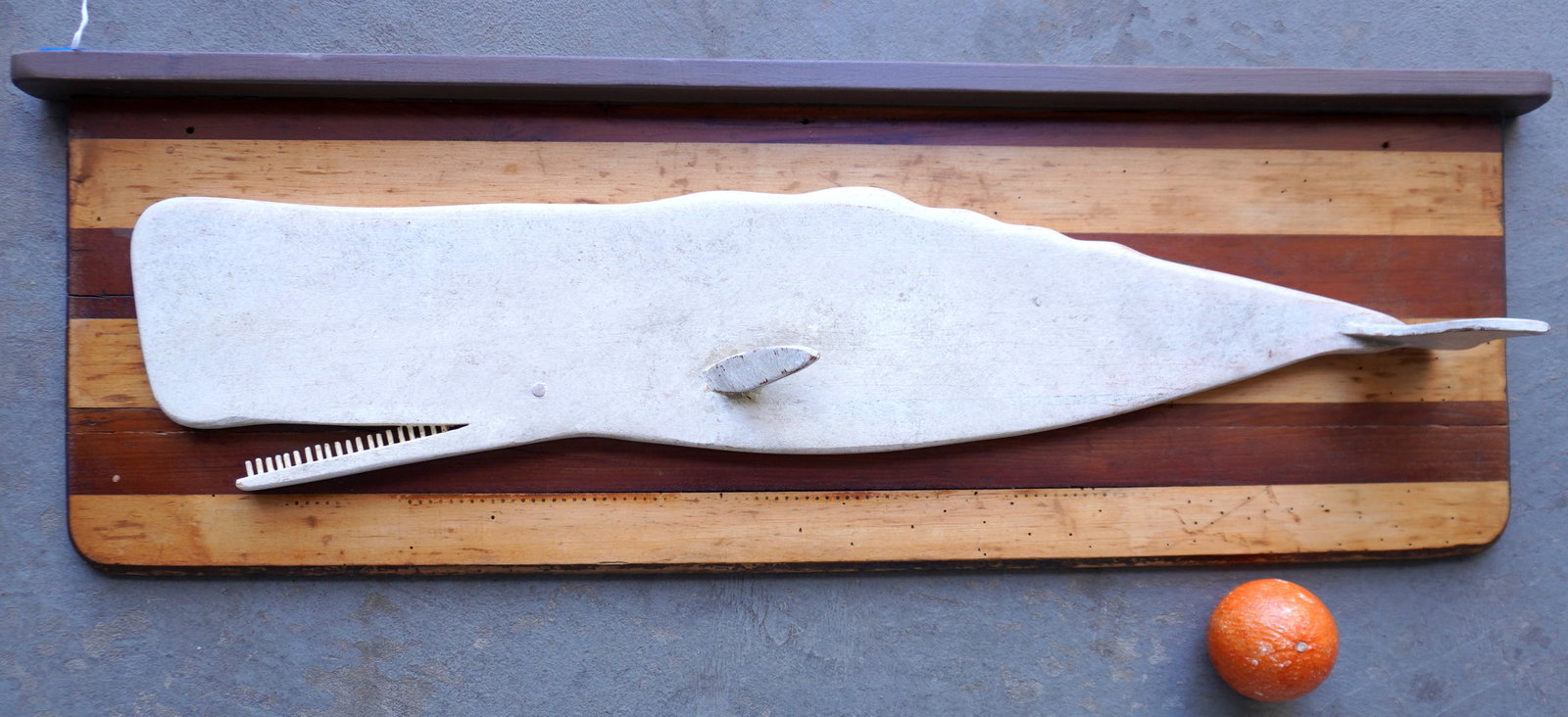 Jeff Raymond, whale plaque carving (1949-2022, Poughkeepsie and Red Hook NY). A Sperm Whale wood: Jeff Raymond, whale plaque carving (1949-2022, Poughkeepsie and Red Hook NY). A Sperm Whale wood carving in original paint, attached to a layered wooden plank, late 20th century, branded JR signature 