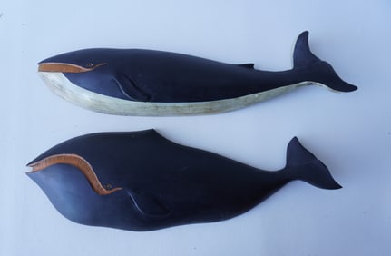 Two silhouette wooden whale carvings including: The first, a Humpback whale in original paint,