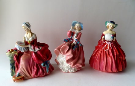 Three Royal Doulton porcelain figurines of fashion ladies including "Penelope", "Genevieve", and