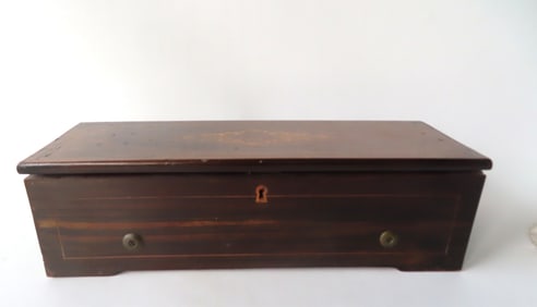 A rosewood cylinder Swiss music box, 8 tunes, with original printed operating instructions on paper
