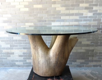 An unusual custom made mid-century rustic kitchen table having a glass top (5' diameter x 1" thick)
