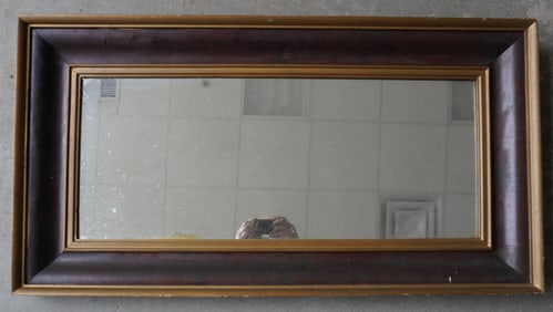 A large Empire mirror with gold highlights, circa 1850 - good condition. Measures 23" x 43".