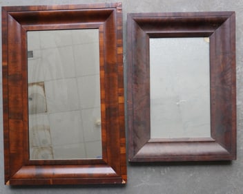 Two Empire ogee mahogany mirrors, both with minor losses to veneer, else good condition. The largest