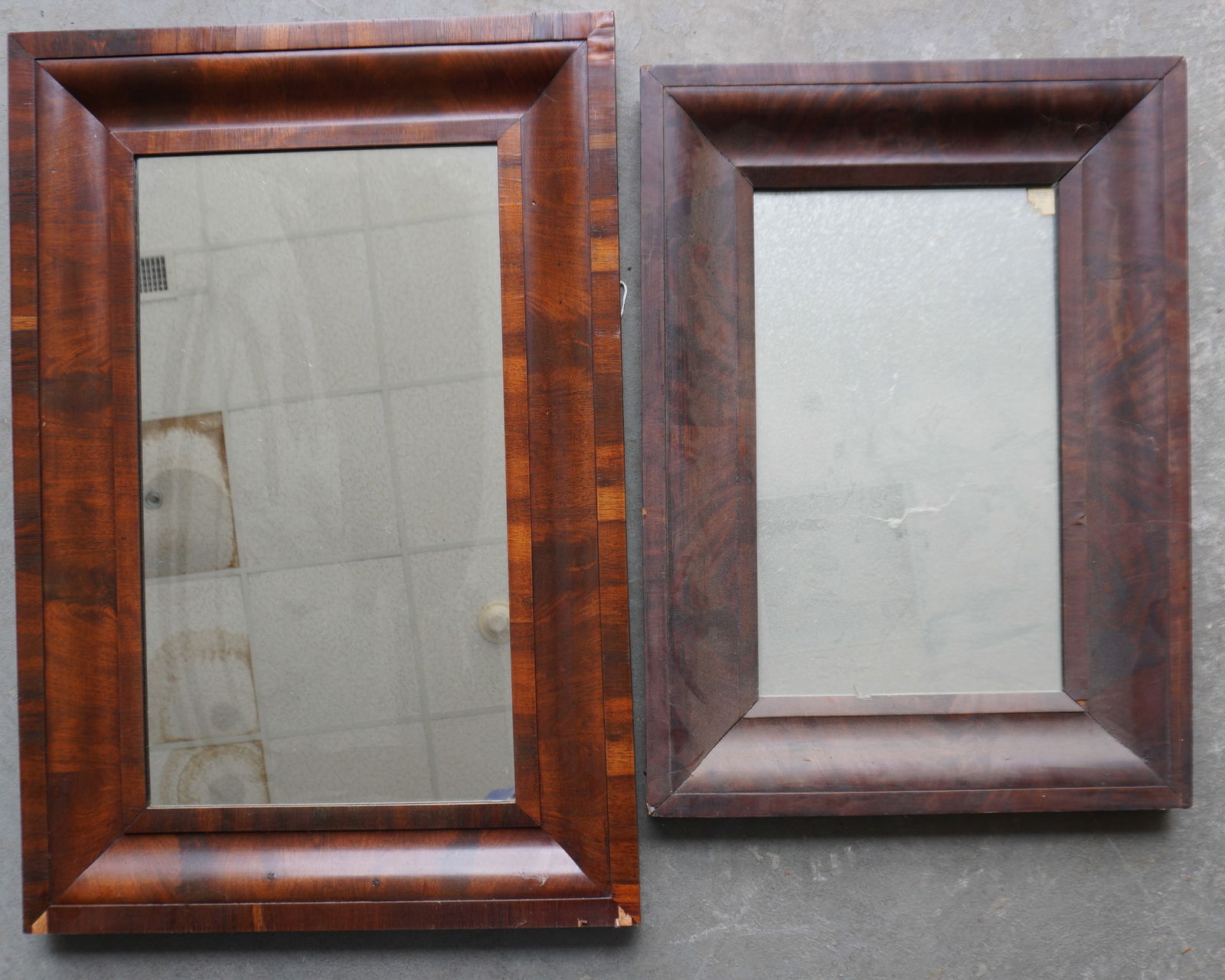 Two Empire ogee mahogany mirrors, both with minor losses to veneer, else good condition. The largest (1 of 7)