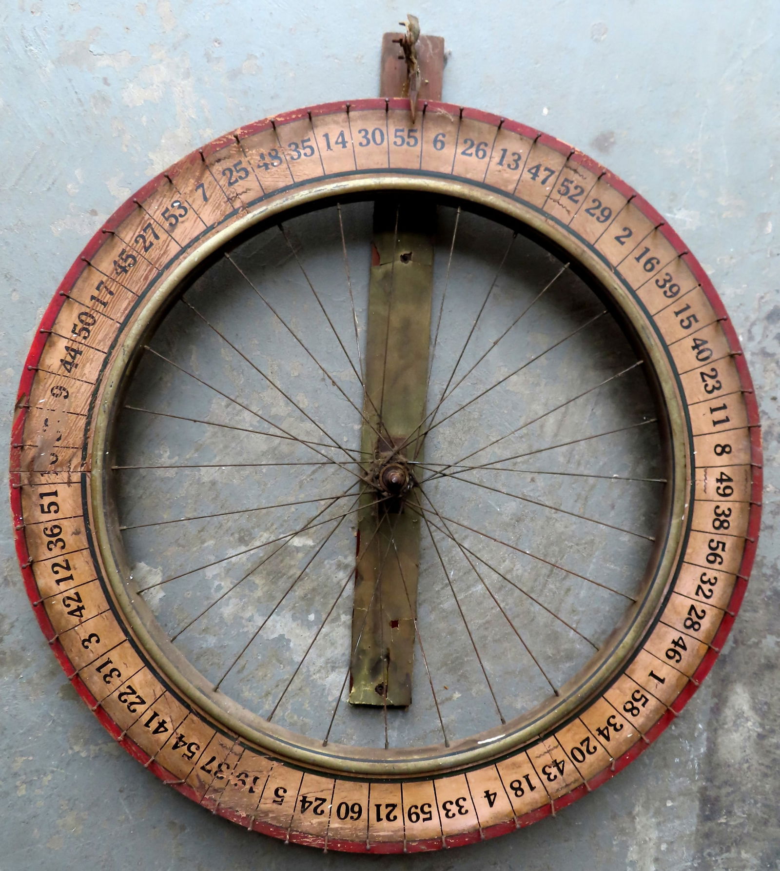 An old carnival gaming wheel in the form of a bicycle wheel, in original red and white paint with (1 of 6)