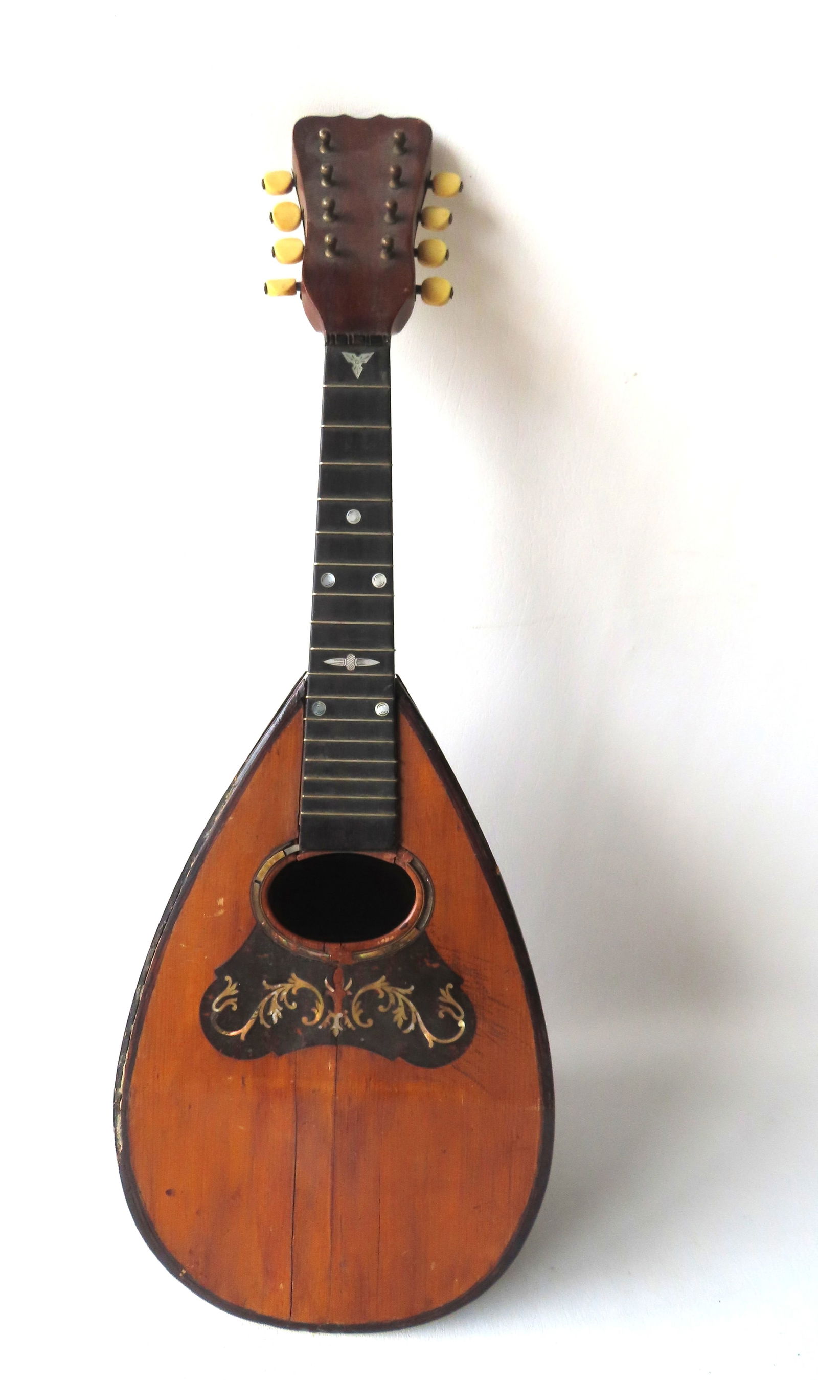 A vintage mandolin with mother of pearl inlays, 8 strings. Missing strings, The top of body with (1 of 6)