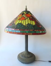 A reproduction Art Nouveau style leaded and slag glass table lamp. The Tiffany style shade by