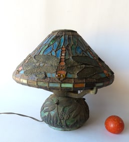 A reproduction Tiffany style slag glass table lamp in the dragon fly pattern.