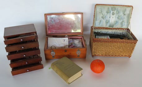 A grouping of sewing notions including 2 sewing baskets with contents, small 4 drawer chest holding