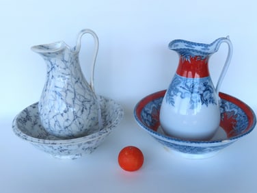 Two 19th century bowl and pitcher sets, both with some damage. The first in blue sponge paint signed