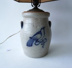 A newer stoneware crock, converted to lamp and decorated with a cobalt blue bird on branch, signed