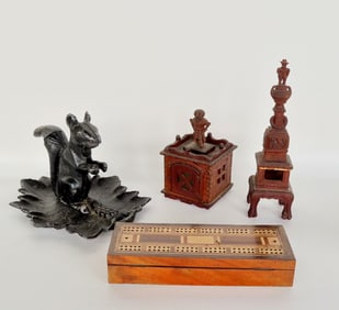 A grouping of country items including an aluminum squirrel nut cracker attached to a leaf shaped