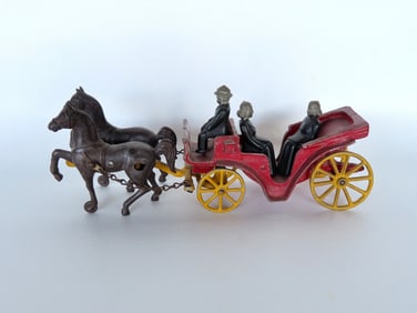 A cast iron horse drawn carriage having 2 horses, driver and 2 passengers, in original paint. Very
