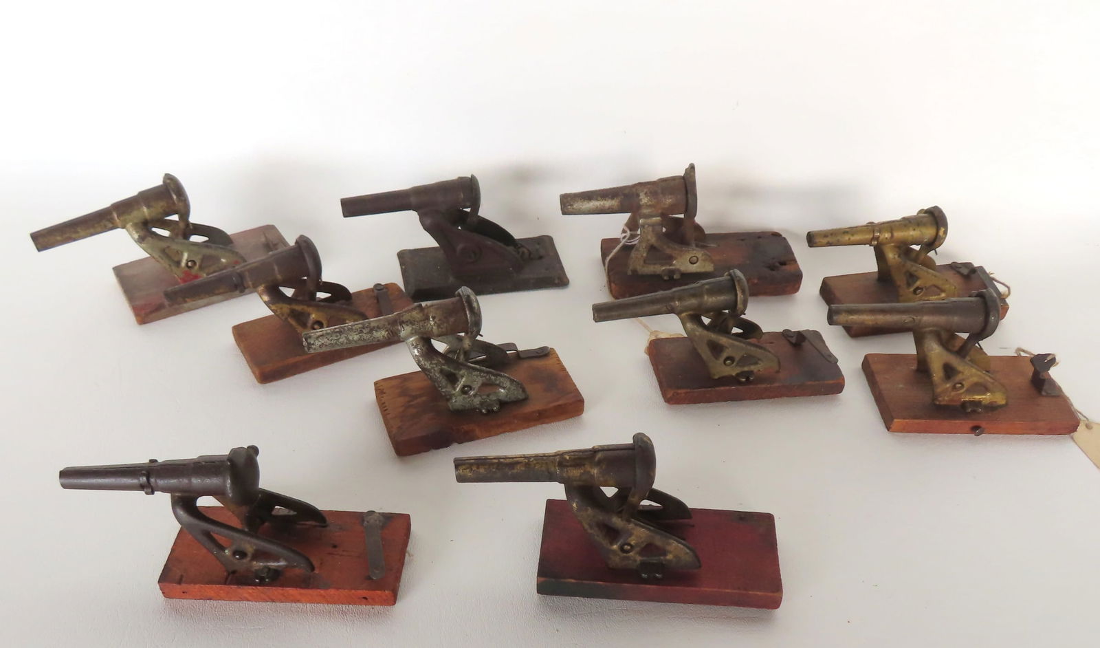 Grouping of 10 toy spring activated cap shooting cannons, circa 1900. Includes 9 in cast iron and 1 (1 of 18)