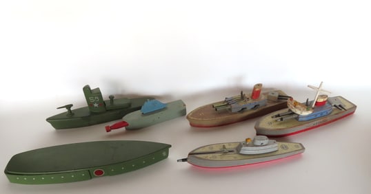Grouping of 6 wooden toy military ships with bullet or torpedo launchers that shoot wooden