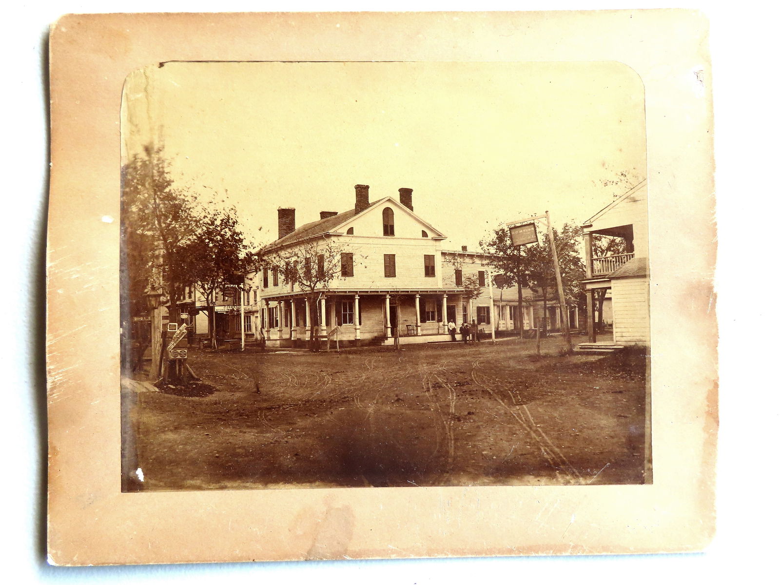A 19th century photograph of the Pine Plains Hotel, owned by Charles Ketterer, the proprietor who: A 19th century photograph of the Pine Plains Hotel, owned by Charles Ketterer, the proprietor who purchased it in 1872. See the original sign hanging from a post to the left of the building marked "Pi
