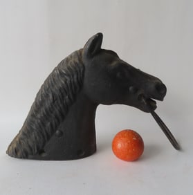 A cast iron horse head hitching post.