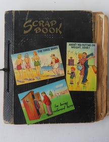 A scrap book with whimsical post cards and newspaper articles, most 1940-50.