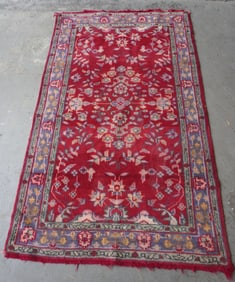 An oriental woven scatter rug, mid to late 20th century.