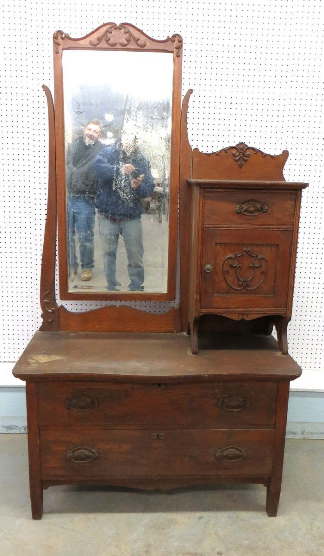 Oak vanity/chest having small cupboard top with 1 drawe: Oak vanity/chest having small cupboard top with 1 drawer over 1 door, base with 2 drawers, large rectangular beveled mirror.