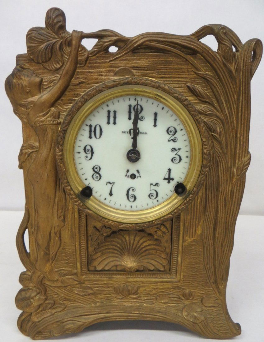 Seth Thomas metal table lamp with bronze finish, decora: Seth Thomas metal table lamp with bronze finish, decorated with lily pads, dragon fly, Art Noveau girl on crest, etc. 11"H x 8.5".