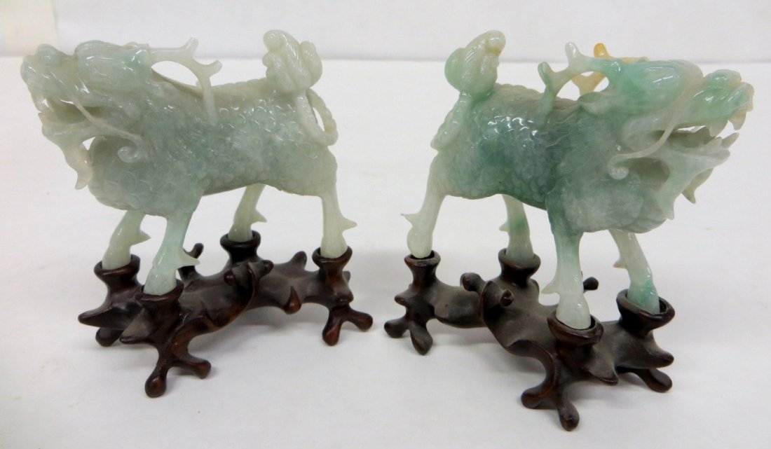 Four Chinese jade figurines - 1930-1960.: Four small jade figurines on ornate oriental wooden stands including women with flowers and birds - 4.5"H x 3"L & 2 foo dogs with antlers (one dog with loss to antler) - 2.5"H x 2.5"L - both measureme