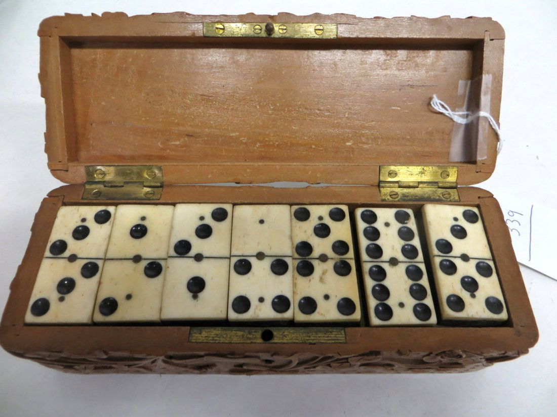 Set of 28 ivory and ebony dominoes in original carved w: Set of 28 ivory and ebony dominoes in original carved wooden box decorated in great detail with flowers and vines - 19th century. Provenance: From the estate of John Whiteford, Wassaic NY.