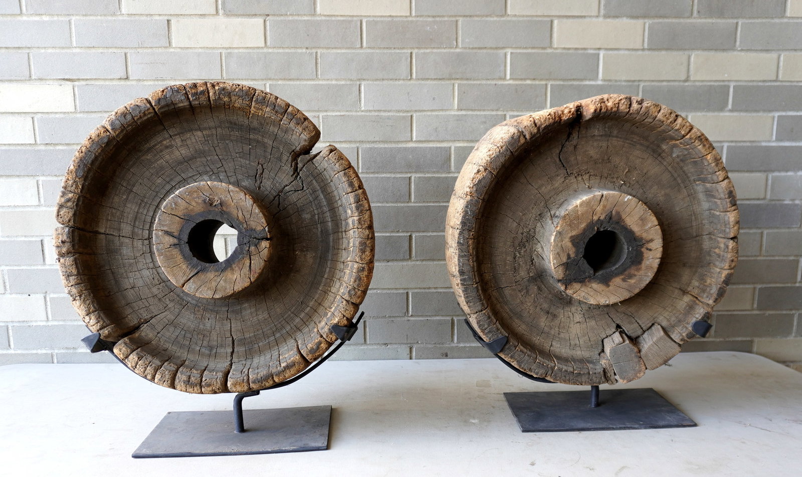 Two early wooden wagon wheels mounted on custom made museum bases for display purposes, probably: Two early wooden wagon wheels mounted on custom made museum bases for display purposes, probably 18th century or earlier. Some use wear, and losses to the wooden surfaces of wheel as could be expected