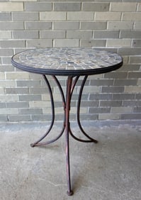 Round patio table with slate top mounted on tri-leg metal base - appears custom made, circa 1970.
