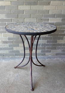 Round patio table with slate top mounted on tri-leg metal base - appears custom made, circa 1970.: Round patio table with slate top mounted on tri-leg metal base - appears custom made, circa 1970. Very good condition. Measures 24" diameter (top) x 28 1/2"H. Provenance: From the June & Bernard