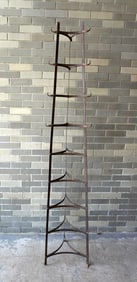 A tall wrought iron stand, graduated in size, for holding cooking pots, mid 20th century or later,
