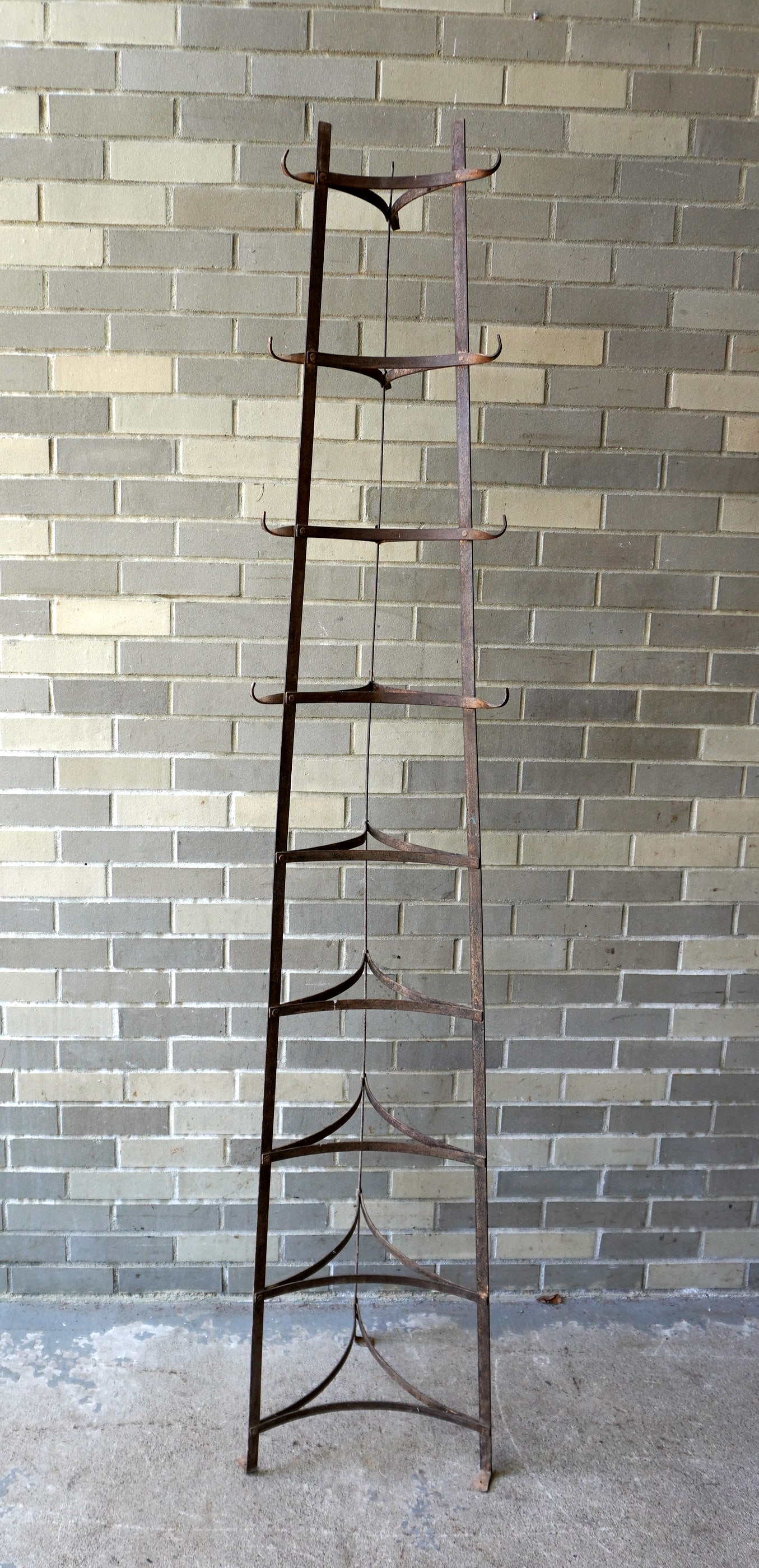 A tall wrought iron stand, graduated in size, for holding cooking pots, mid 20th century or later,: A tall wrought iron stand, graduated in size, for holding cooking pots, mid 20th century or later, very good condition. 79"H x 16"W at base. Provenance: From the Marni Bakst and William Sadler collect