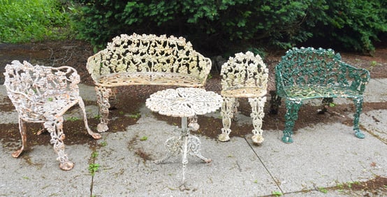 Five pieces of cast iron garden furniture in the grape and vine pattern, most needing some work and