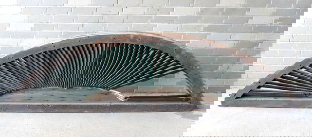 A very large architectural half round louvered window (vent), 19th century. Losses to louvers, else
