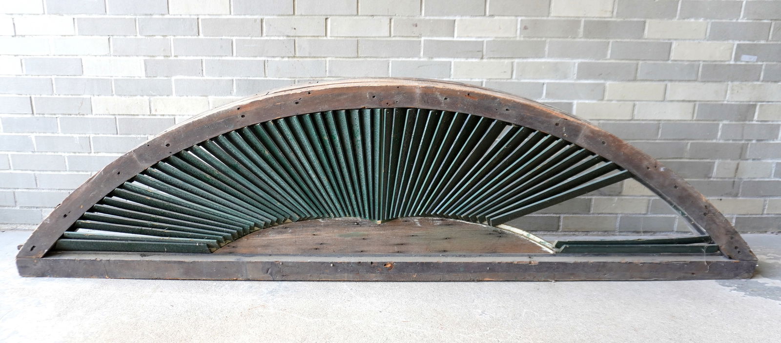 A very large architectural half round louvered window (vent), 19th century. Losses to louvers, else: A very large architectural half round louvered window (vent), 19th century. Losses to louvers, else fair to good condition. Measures 89"W x 10"D x 23"H. Provenance: From the Marni Bakst and William Sa
