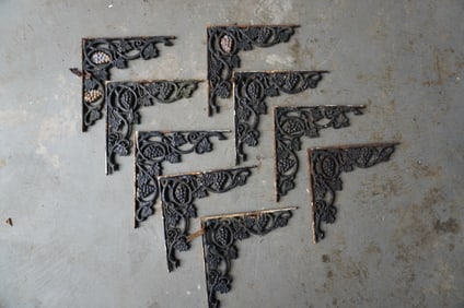 A grouping of 9 cast iron grape and vine pattern shelf brackets, 19th century. All with layers of