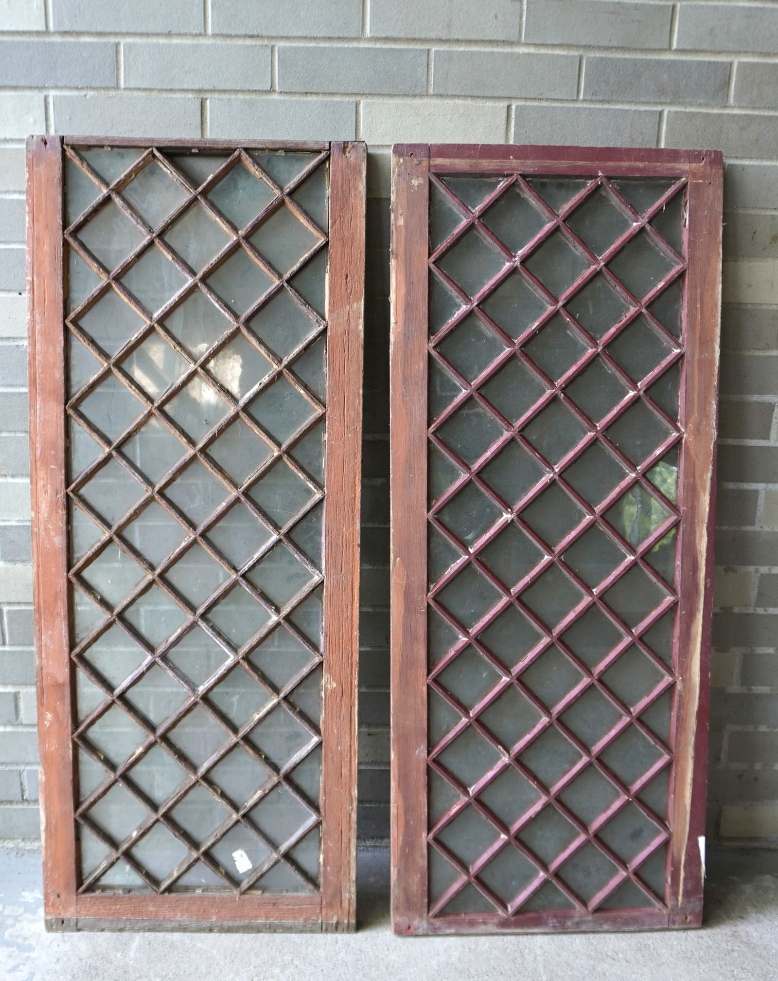 Two matching diamond pattern wooden windows, late 19th century, both in good condition. Each: Two matching diamond pattern wooden windows, late 19th century, both in good condition. Each approximately 43 1/4"H x 18"W. Provenance: From the Marni Bakst and William Sadler collection of antiques,