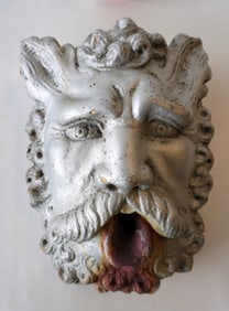 An early cast stone fountain in the form of Neptune face with open mouth, late 19th to early 20th