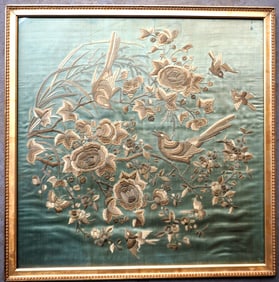 A silk embroidery depicting birds perched and flying within and around branches of flowers, very