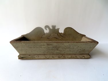 An primitive cutlery box in original pale green paint, and the shaped handle in the form of 2 birds,