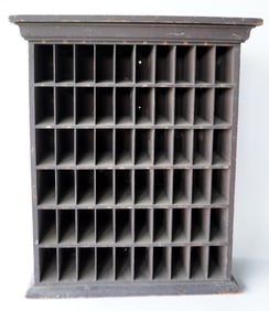 A cubby hole unit with 60 open slots, 19th century. Can be either hung on wall or used as a table