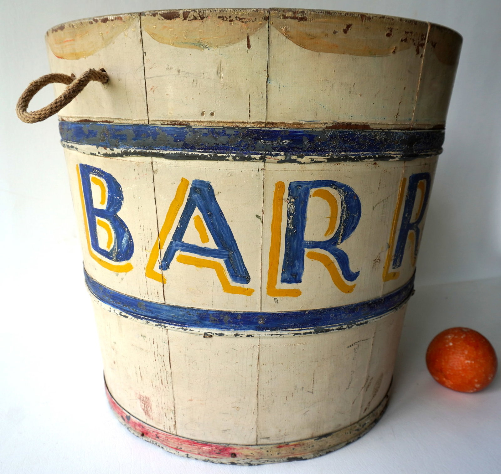 A colorful hand painted circus animal feed bucket with rope handles, marked with shadow lettering: A colorful hand painted circus animal feed bucket with rope handles, marked with shadow lettering "Barry". Good condition in original paint, late 19th century. 15 1/4" diameter x 14 1/2"H. Provenance: